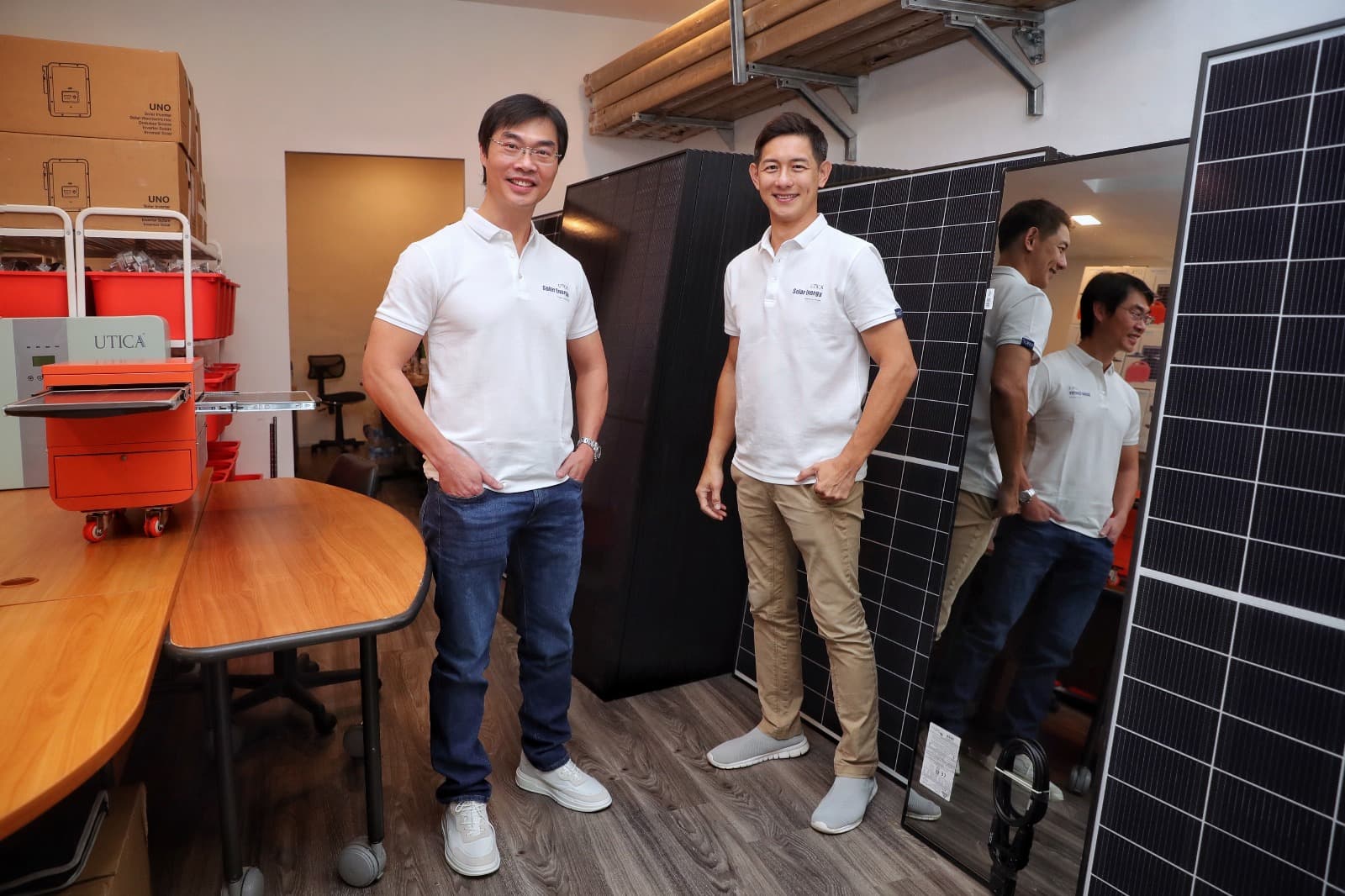UTICA founders beside solar panels
