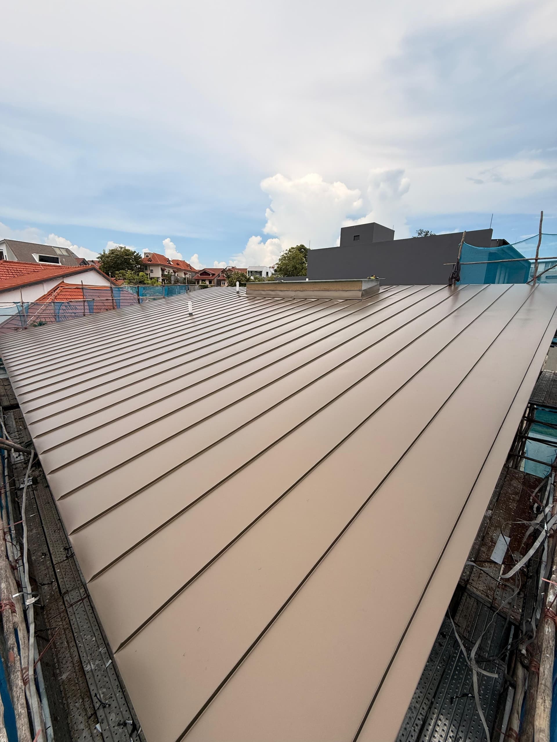 Completed PVDF-coated aluminium standing seam roof at Siglap View