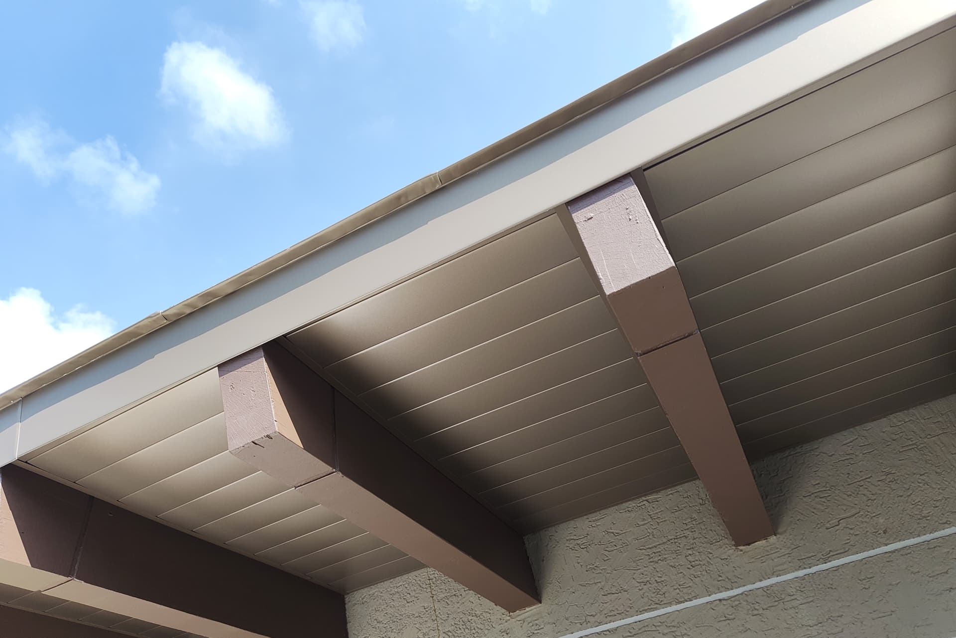 Aluminium strip soffit installed beneath the completed roof edge