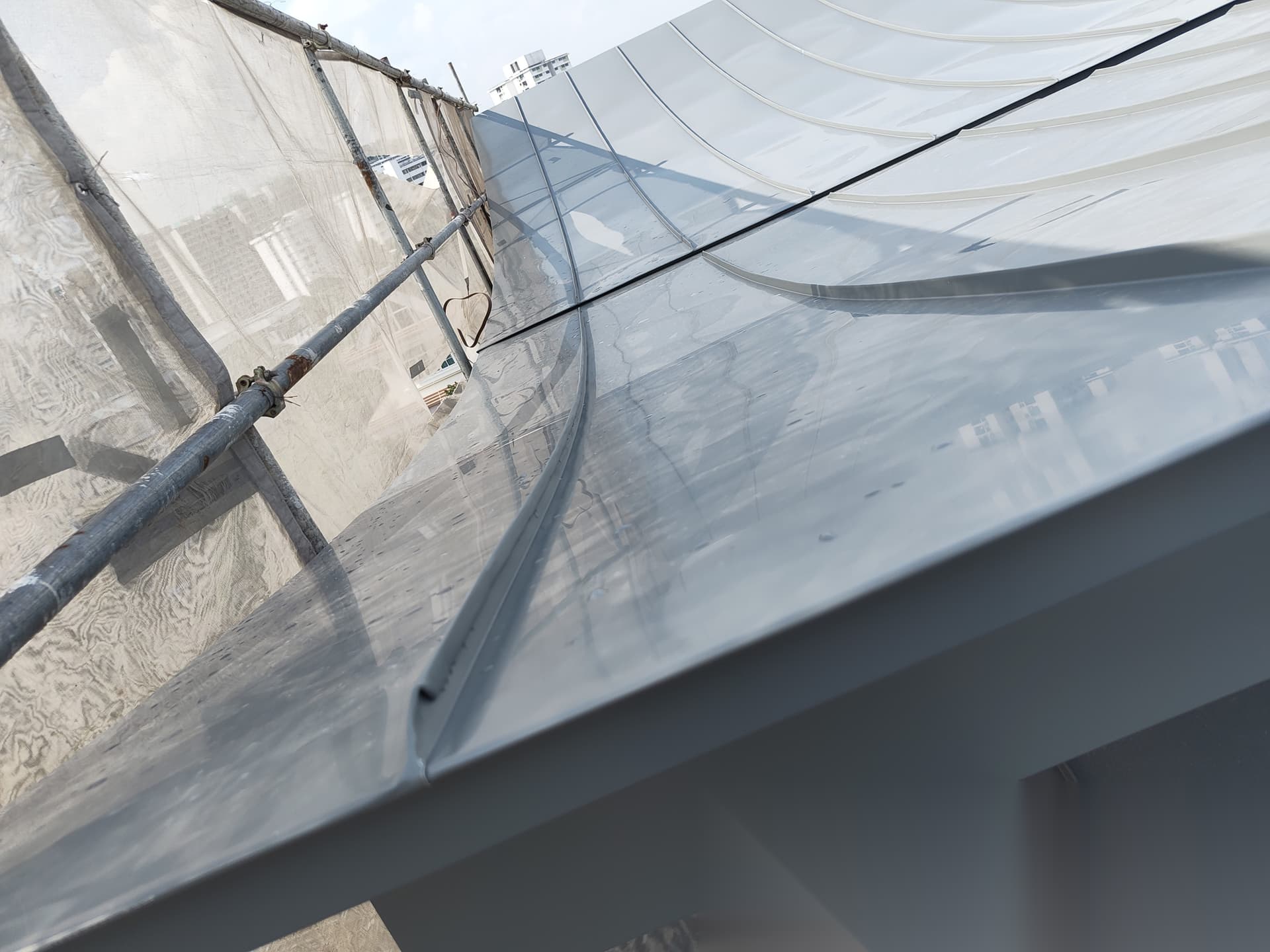 Close view of the curved roof edge and metalwork detail
