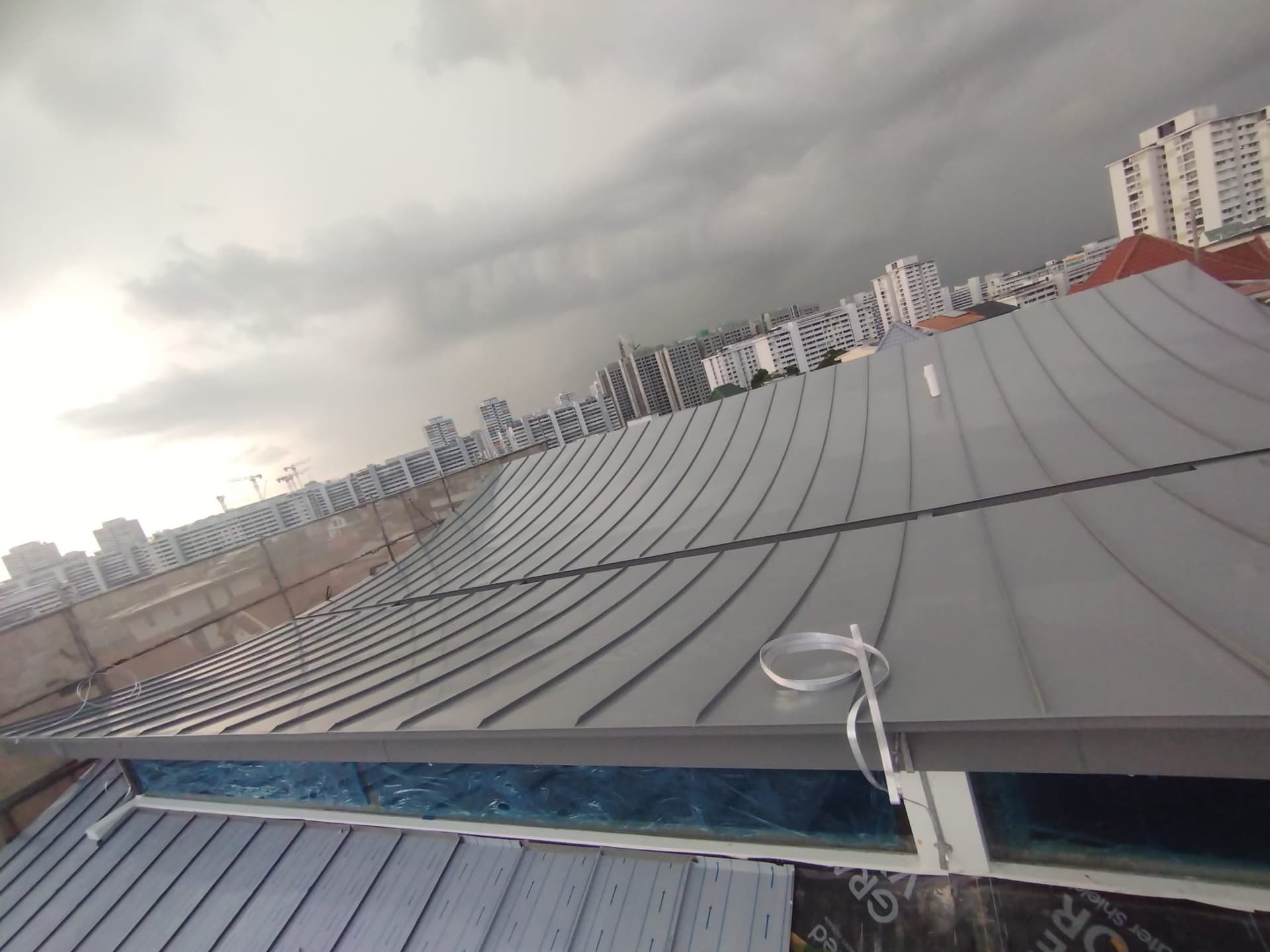 Completed curved metal roof viewed from the roof edge